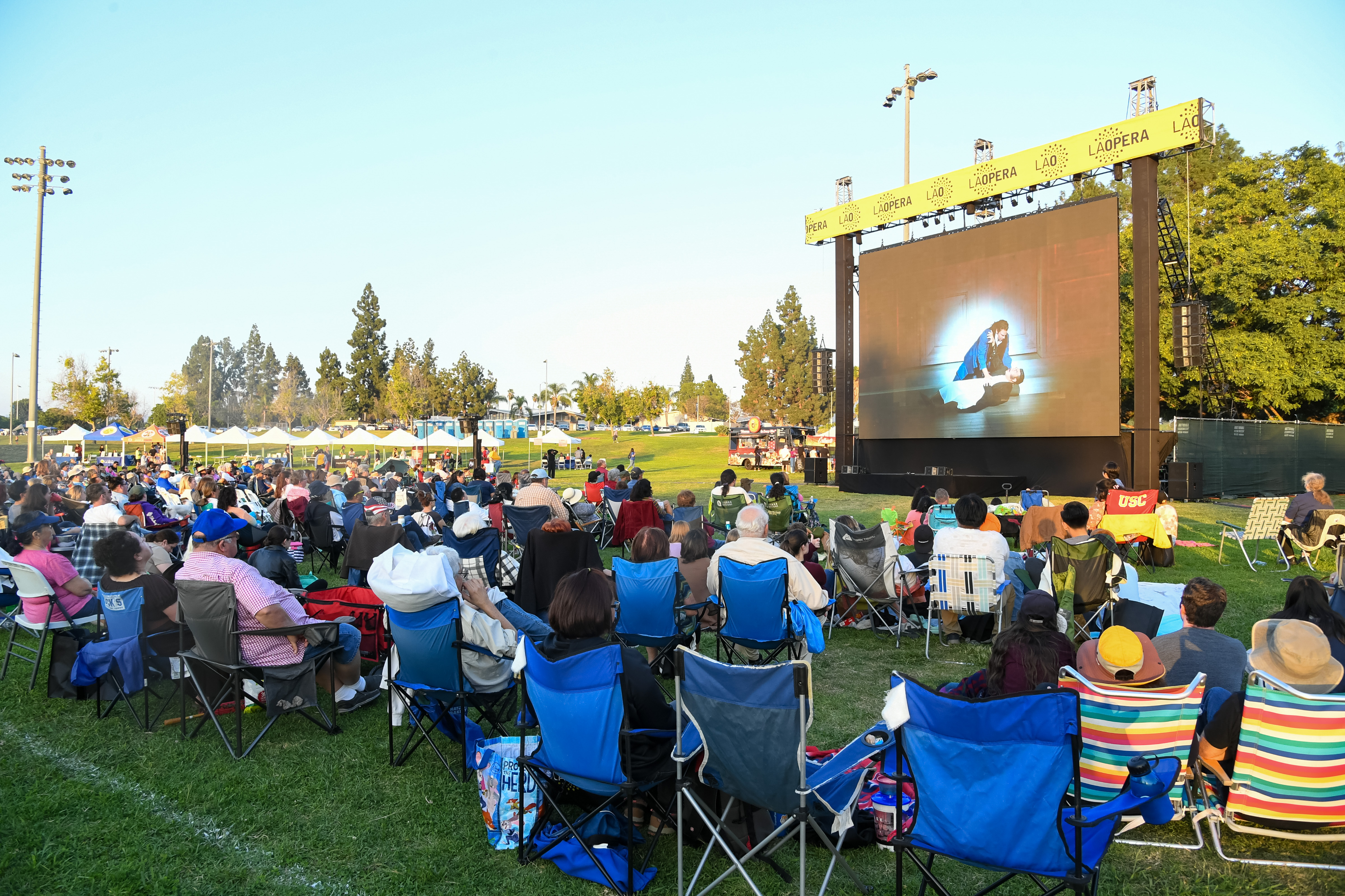 People viewing an opera in the park