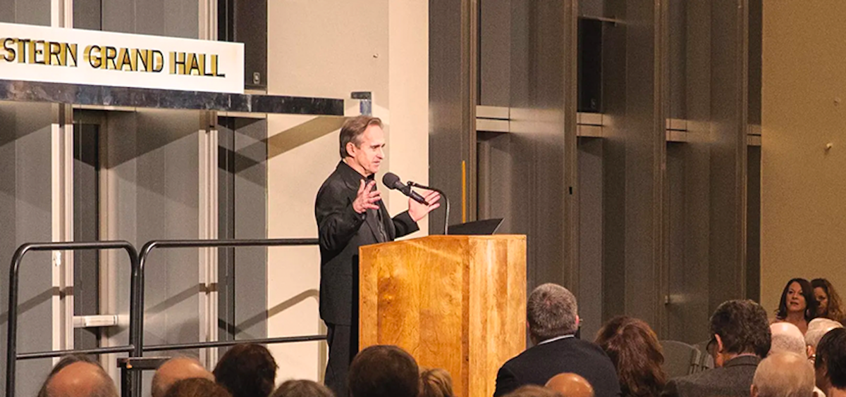 Man speaking at a podium